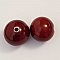 Deux perles en céramique émaillée rouge de 30 mm.