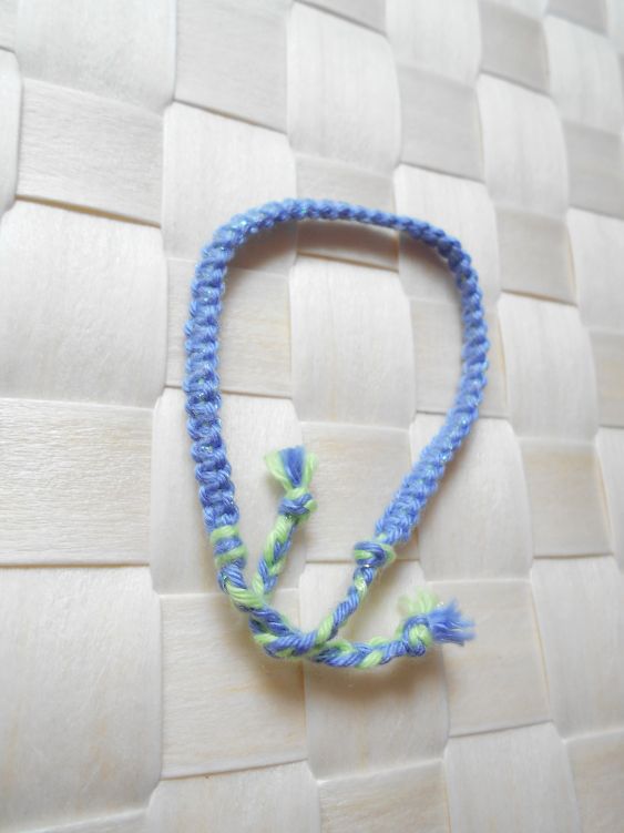 Bijou de poignet en macram&eacute; plat 4 fils, coloris bleuet vert d'eau, agr&eacute;ment&eacute; d&rsquo;un fil lurex tr&egrave;s fin bleu m&eacute;tallis&eacute;