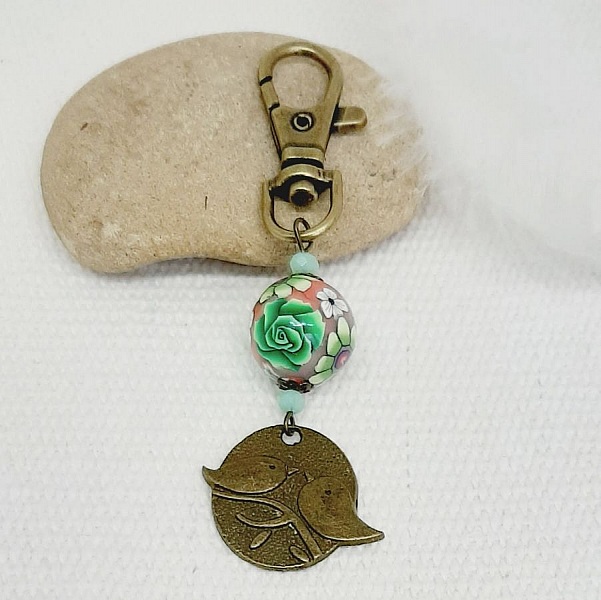 porte cl&eacute; m&eacute;daille duo d'oiseaux couleur bronze et perle artisanale motif floral vert et lie de vinmulticolore