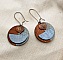 Boucles d'oreilles graphiques en bois avec pendentif feuille cuivrée.