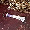 Porte-clé macramé étoile en coton avec pompon violet.