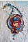 Collier brodé artisanal avec cabochon vintage et perles colorées.