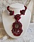 Collier Rubby One brod&eacute;  avec un cabochon en c&eacute;ramique de couleur Gris/Marron &agrave; laquelle s'ajoute des cabochons ronds en Cristal Siam, rocailles Bronze, toupies Light Rose et Rubby avec fermoir en T