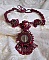 Collier Rubby One brod&eacute;  avec un cabochon en c&eacute;ramique de couleur Gris/Marron &agrave; laquelle s'ajoute des cabochons ronds en Cristal Siam, rocailles Bronze, toupies Light Rose et Rubby avec fermoir en T