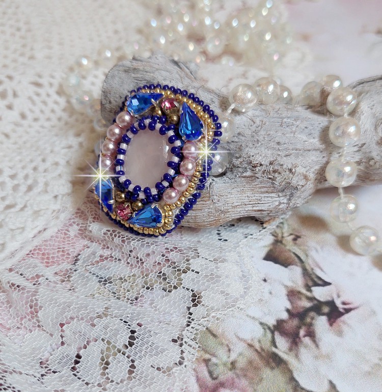 Bague Gabrielle brod&eacute;e avec un cabochon ovale en pierre de gemme : le Quartz Rose &agrave; laquelle s'ajoute des cabochons poires et chatons en Cristal, perles nacr&eacute;es, rocailles sur bague en laiton Bronze