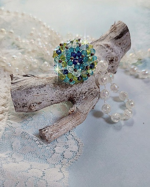 Bague Esp&eacute;rance mont&eacute;e avec toupies Aquamarine AB, Blue Zircon, Capri Blue, Olivine AB, Cristal avec des facettes entrelac&eacute;es avec des rocailles. Elle s&rsquo;adaptera parfaitement &agrave; votre doigt