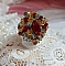 Bague Iroise mont&eacute;e avec des toupies et une navette en Cristal aux couleurs Rouge, Jaune, Topaz et Vert entrelac&eacute;es avec des rocailles Bronze sur des facettes en verre de boh&egrave;me Rouge