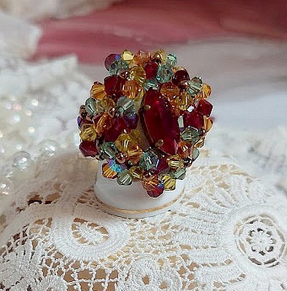 Bague Iroise mont&eacute;e avec des toupies et une navette en Cristal aux couleurs Rouge, Jaune, Topaz et Vert entrelac&eacute;es avec des rocailles Bronze sur des facettes en verre de boh&egrave;me Rouge