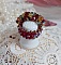 Bague Iroise mont&eacute;e avec des toupies et une navette en Cristal aux couleurs Rouge, Jaune, Topaz et Vert entrelac&eacute;es avec des rocailles Bronze sur des facettes en verre de boh&egrave;me Rouge