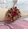 Bague Iroise mont&eacute;e avec des toupies et une navette en Cristal aux couleurs Rouge, Jaune, Topaz et Vert entrelac&eacute;es avec des rocailles Bronze sur des facettes en verre de boh&egrave;me Rouge