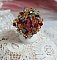 Bague Iroise mont&eacute;e avec des toupies et une navette en Cristal aux couleurs Rouge, Jaune, Topaz et Vert entrelac&eacute;es avec des rocailles Bronze sur des facettes en verre de boh&egrave;me Rouge