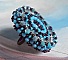 Bague Na&iuml;ade brod&eacute;e avec un cabochon facett&eacute; Turquoise, chatons, toupies en Cristal de Swarovski, rocailles sur une bague de couleur Bronze et sur du cuir vachette Camel 