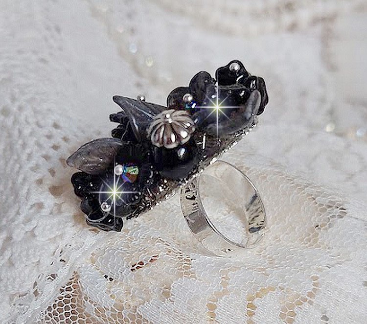 Bague Soir de Lune cr&eacute;&eacute;e avec des fleurs lucites Noires et Grises peintes &agrave; la main, cristaux, perles en r&eacute;sine, perles en verre et coupelle argent&eacute;e. Le tout est mont&eacute; sur une bague argent&eacute;e