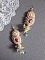 BO Envol&eacute;e Fleurie brod&eacute;es avec des cabochons ovales et ronds aux couleurs : Light Fuchsia et Ivoire, orn&eacute;s de perles rondes, fleurs Lucites et rocailles. Mont&eacute;es sur crochets en Gold Filled 14 carats