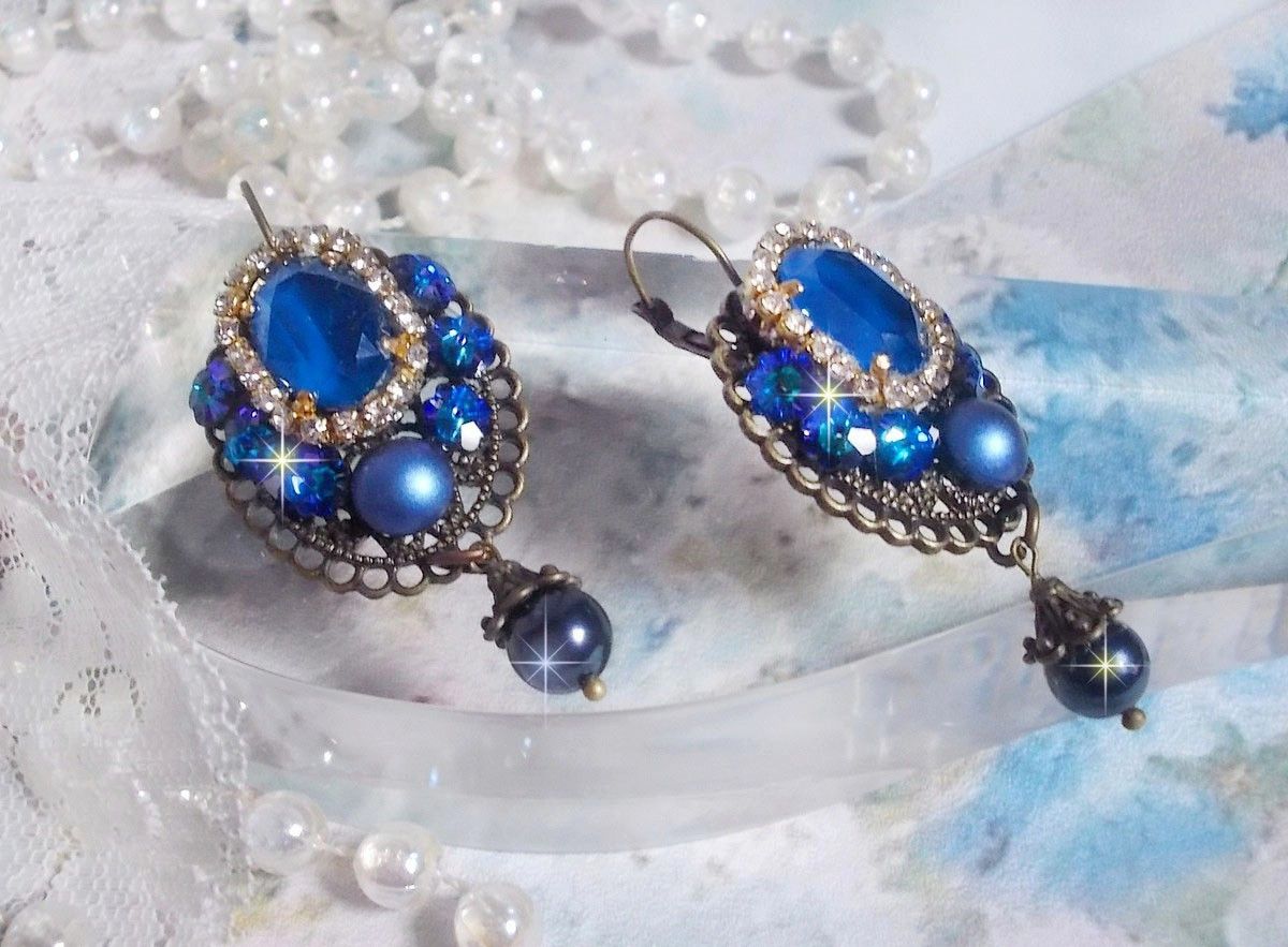 BO Leila avec des cabochons ovales de couleur Royal Blue &agrave; laquelle s&rsquo;ajoute des cabochons ronds, perles nacr&eacute;es et fleurs. Ils sont tous en Cristal, les dormeuses couleur Bronze sont en Laiton