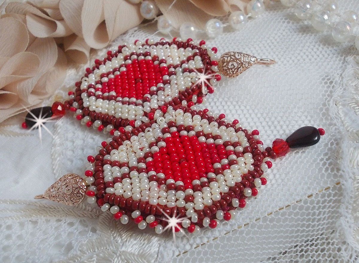 BO Romane brod&eacute;es avec des rocailles en verre Rouge, Bordeaux, Ivoire &agrave; laquelle s'ajoute des gouttes plates Grenat. Le tout est mont&eacute; sur des crochets en Laiton d&eacute;cor goutte