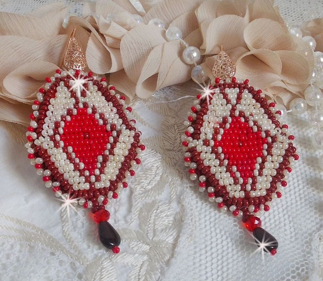 BO Romane brod&eacute;es avec des rocailles en verre Rouge, Bordeaux, Ivoire &agrave; laquelle s'ajoute des gouttes plates Grenat. Le tout est mont&eacute; sur des crochets en Laiton d&eacute;cor goutte