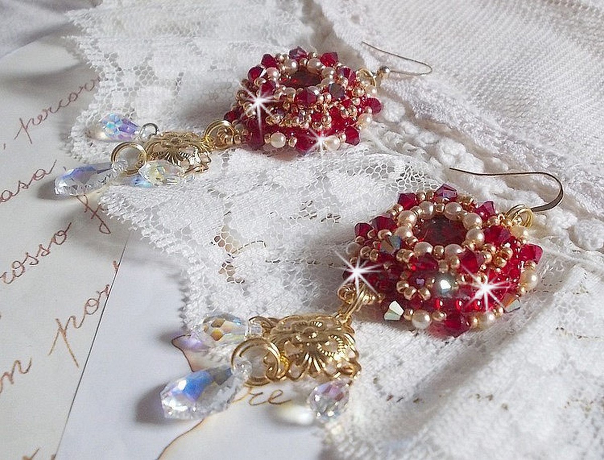 BO Rubis brod&eacute;es avec des cabochons Light Siam orn&eacute;s de toupies Rouges &agrave; laquelle s&rsquo;ajoute perles nacr&eacute;es Ivoires, estampes Dor&eacute;es, gouttes baroques en Cristal AB et crochets en Gold Filled 14 carats