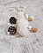 BO Cassandre avec des pierres de gemme : le Howlite Blanc &agrave; laquelle s&rsquo;ajoute des pompons, des intercalaires rondelles, des coupelles feuilles et breloques. Mont&eacute;s sur des puces Noires et Dor&eacute;es 