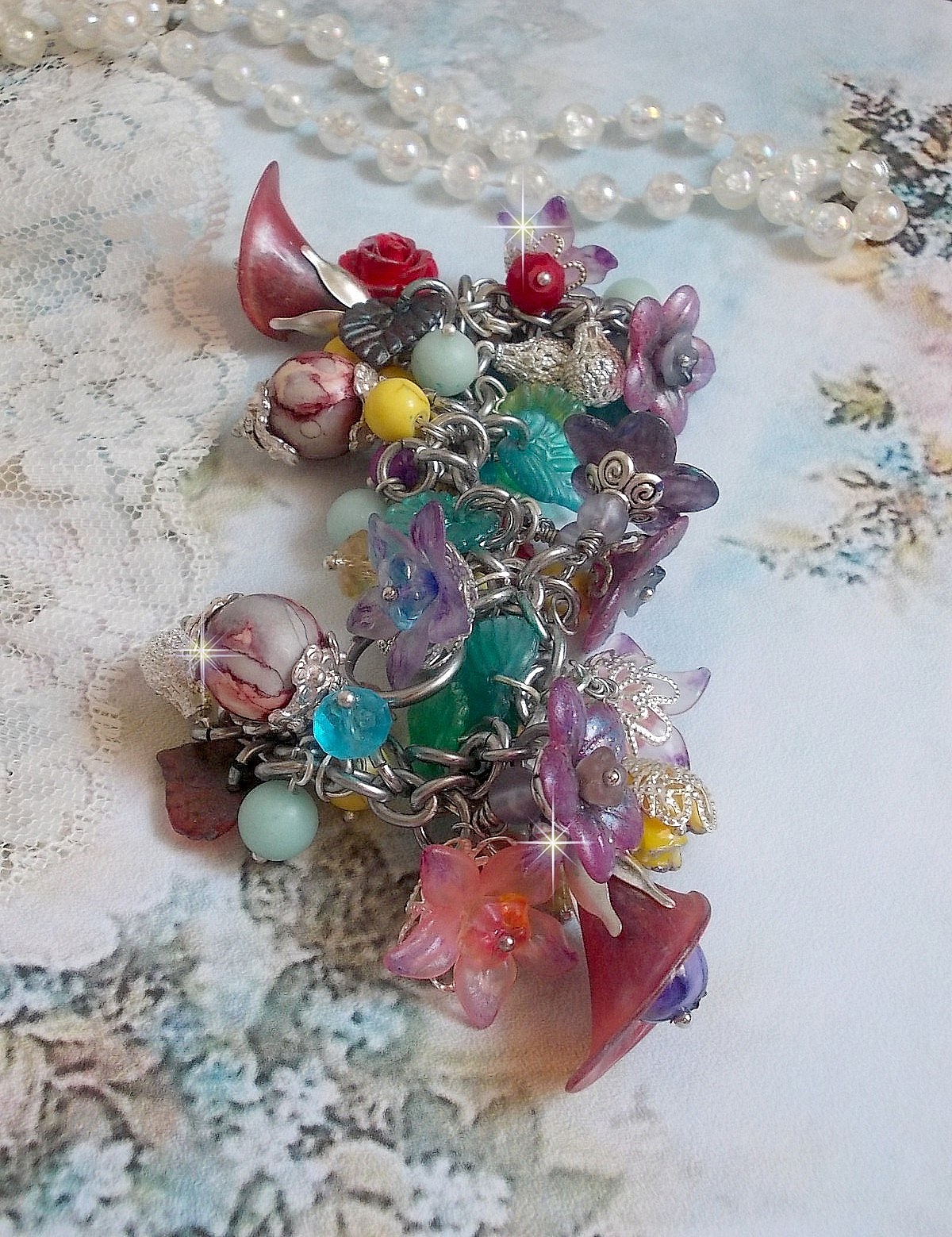 Bracelet Lady Luxe mont&eacute; avec des perles de gemme : L&rsquo;Amazonite et la Sugilite &agrave; laquelle s&rsquo;ajoute des fleurs de diff&eacute;rentes vari&eacute;t&eacute;s peintes &agrave; la main : lucite et r&eacute;sine, breloques et perles