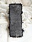 Bracelet manchette brodé noir sur fond de dentelle blanche.
