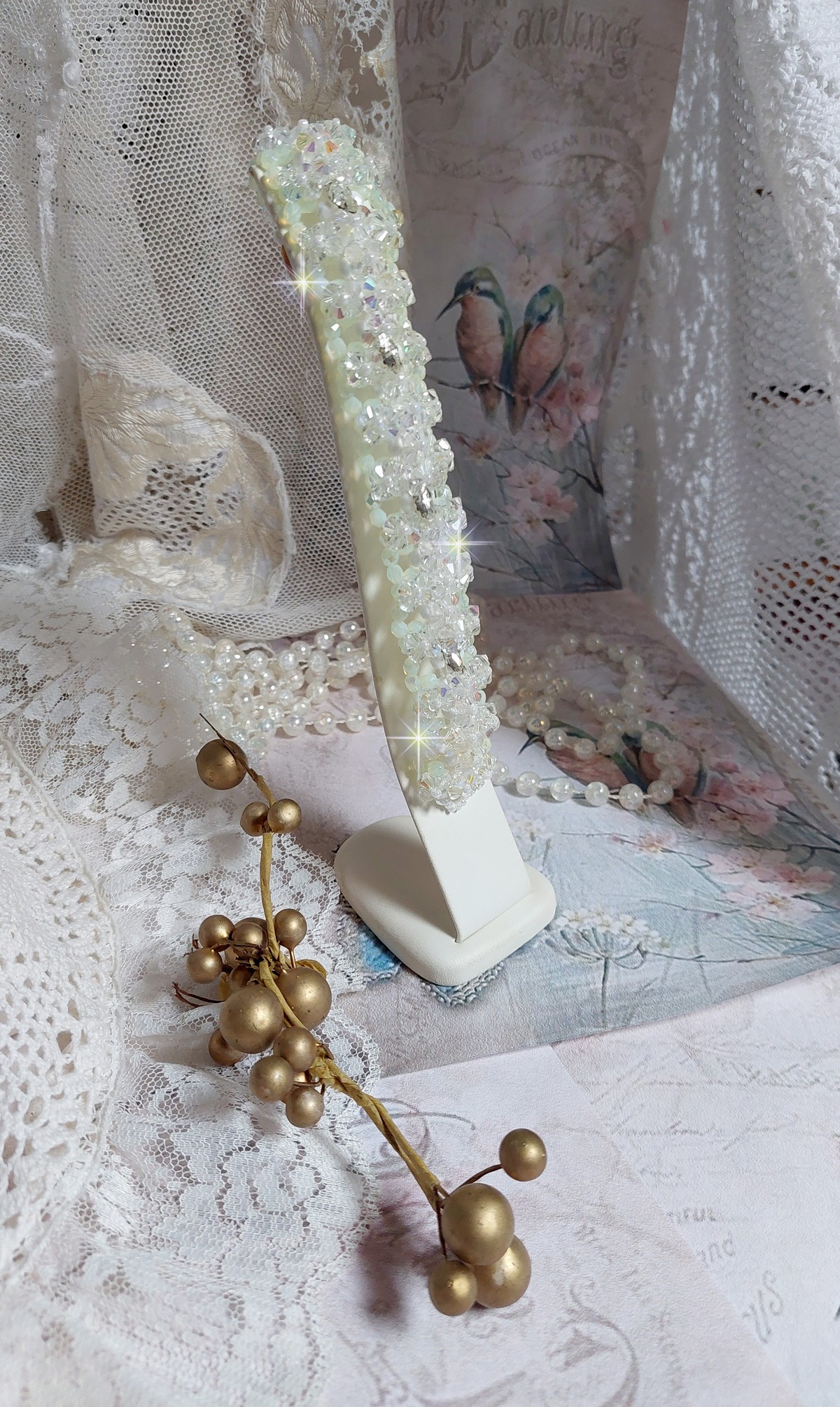 Bracelet V&eacute;nus mont&eacute; avec une cascade de cristaux : toupies et navettes en Cristal AB ainsi que les facettes de couleur Blanche et Beige Opaque de qualit&eacute; AB, puis perl&eacute; de rocailles nacr&eacute;es 