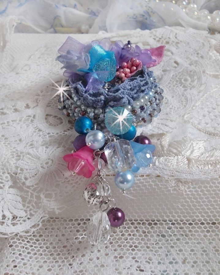 Broche Mademoiselle Bluse Haute Couture brod&eacute; avec dentelle Gris perl&eacute;, rubans : satin et organza, fleurs en tissu &agrave; laquelle s&rsquo;ajoute des cristaux : perles, navette, toupies et fleurs en r&eacute;sine
