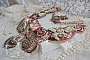 Plastron Arc-En-Ciel Haute-Couture brod&eacute; avec un cabochon en porcelaine de Limoge, des cristaux de Swarovski et des nacres. 