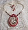 Collier Drigon Red brod&eacute; avec des navettes et cabochons aux couleurs Rouge, Cristal et Argent&eacute;, repr&eacute;sentant une femme Dragon, strass, rocailles, facettes, cha&icirc;nettes et fermoirs en argent 925/1000
