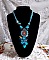 Collier Turquoise Haute Couture au Style Am&eacute;rindien brod&eacute; sur du Cuir avec des cabochons ronds Nacre Acajou et Prune, s&rsquo;ajoute un cabochon Turquoise. Orn&eacute; de cristaux, ruban, perles et rocailles 