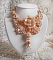 Plastron Idylle Beaut&eacute; Haute Couture brod&eacute; avec cabochons perl&eacute;s de perles rondes nacr&eacute;es en Cristal de Swarovski, des toupies et des rocailles de couleur Saumon, une belle harmonie avec le design 
