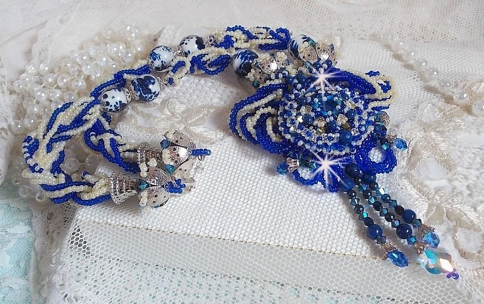 Collier Lotus Flowers avec un cabochon en Verre brod&eacute; sur une base en su&eacute;dine &agrave; laquelle s&rsquo;ajoute :  perles de Venise, coupelles estampes, toupies, chatons, gouttes, rocailles et fermoir Argent 925