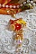 Pendentif Bouton d&rsquo;Or brod&eacute; avec du fil coton Jaune, fleurs, feuilles, rocailles, cristaux, cha&icirc;ne plaqu&eacute;e or, inspiration contemporaine.