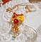 Pendentif Bouton d&rsquo;Or brod&eacute; avec du fil coton Jaune, fleurs, feuilles, rocailles, cristaux, cha&icirc;ne plaqu&eacute;e or, inspiration contemporaine.