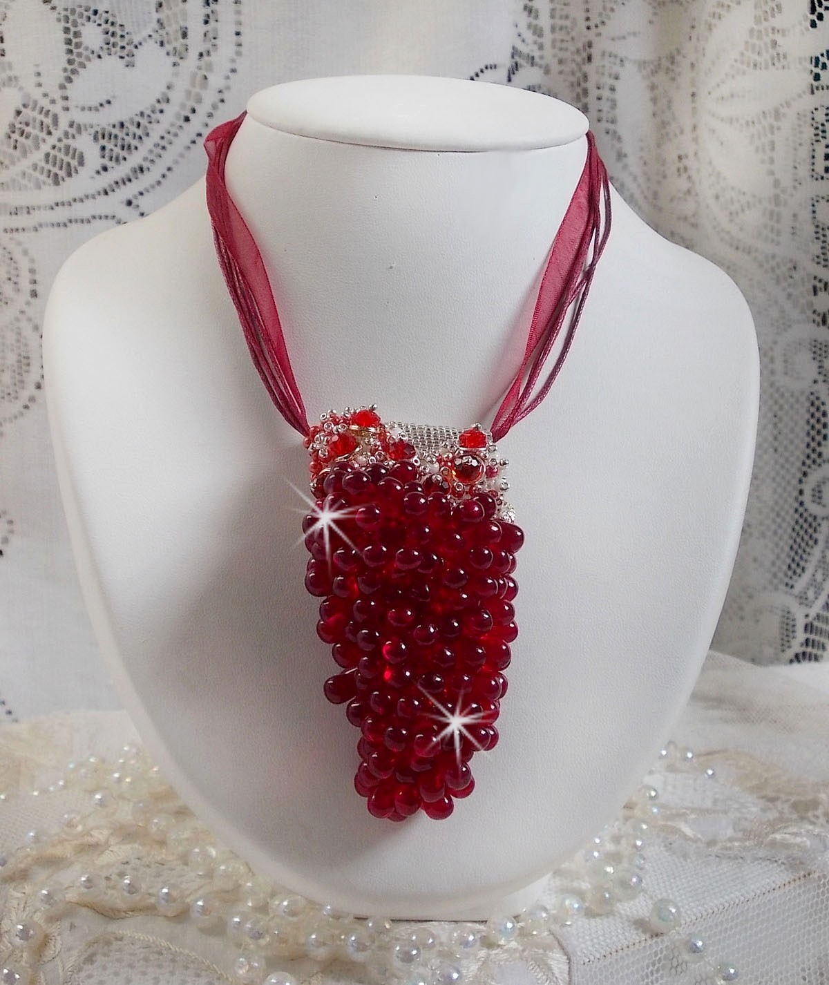 Pendentif Tendre Rouge mont&eacute; avec des gouttes en verre rouge, des perles rondes facett&eacute;es et des perles nacr&eacute;es