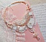 Plastron Bouquet d'un Jour Haute Couture brod&eacute; avec des fleurs en Nacre &agrave; laquelle s'ajoute cristaux, perles rondes, cabochon rond, perles nacr&eacute;es avec fermoir et cha&icirc;nette Argent 925