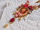 Collier artisanal Roseraie Provençale avec roses et nœud rouge.