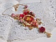 Collier artisanal Roseraie Provençale avec roses et nœud rouge.