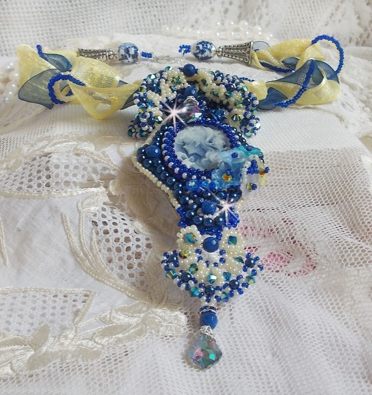 Pendentif haute couture brodé perles bleues, cristaux et rubans.