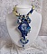 Pendentif haute couture brodé bleu avec perles et cristaux.