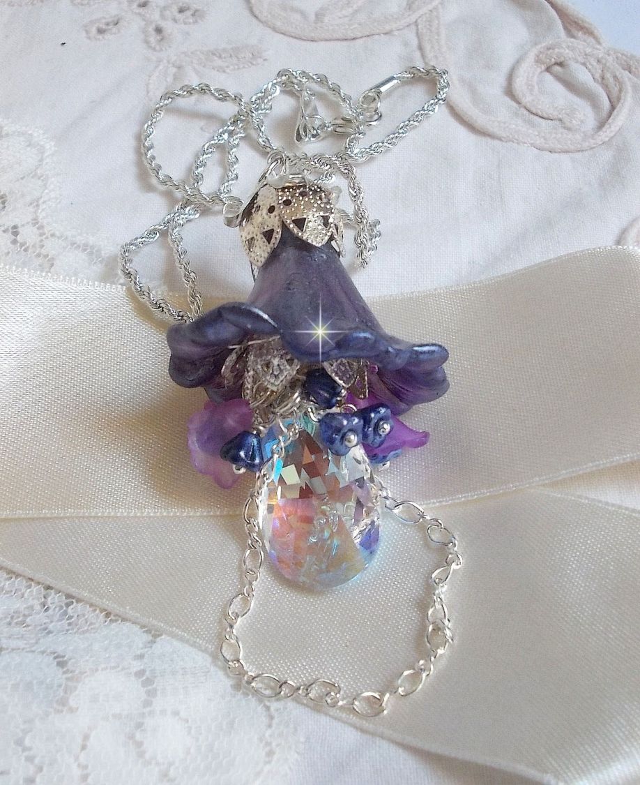Pendentif Eclat de Cristal mont&eacute; avec une goutte en Cristal, fleurs en Verre, fleurs lucites dont une plus grande peinte &agrave; la main avec paillettes Argent&eacute;es. Une composition florale