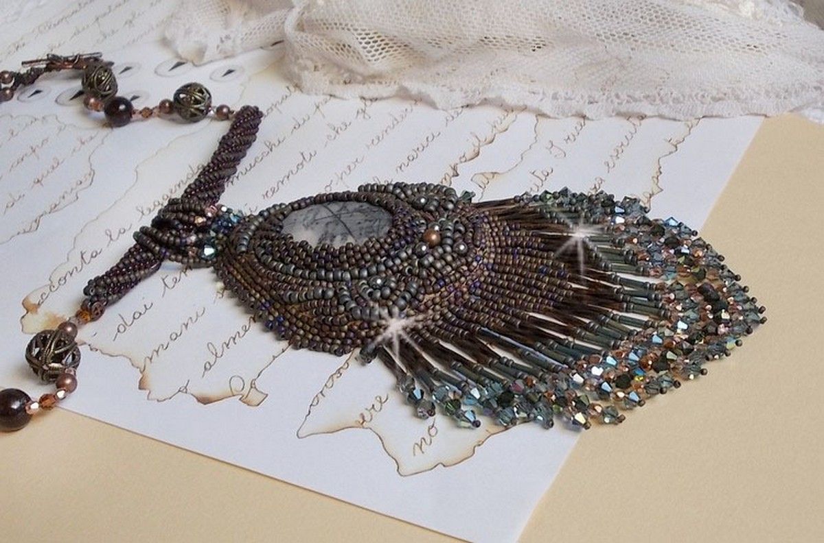 Pendentif Long Brown Picasso avec un cabochon Jaspe Picasso orn&eacute; de rocailles en verre de qualit&eacute; et tailles diff&eacute;rentes, toupies, perles rondes nacr&eacute;es, rondes filigran&eacute;es et lisses. Style Ethnique