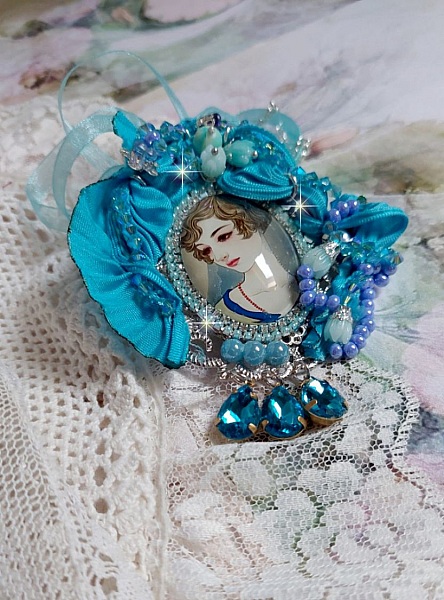 Pendentif Mademoiselle au style r&eacute;tro avec cabochon d&rsquo;une femme souriante, orn&eacute; d&rsquo;un ruban de soie Bleu, cristaux, perles verre : rocailles et roses, coupelles et cha&icirc;ne Argent 925/1000