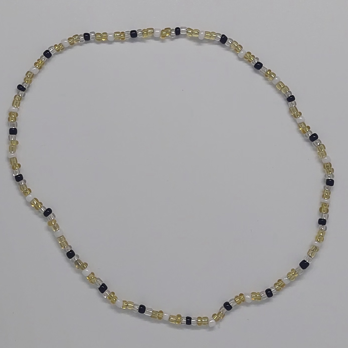 Ras du cou &eacute;lastique dor&eacute; et noir en perles de rocaille
